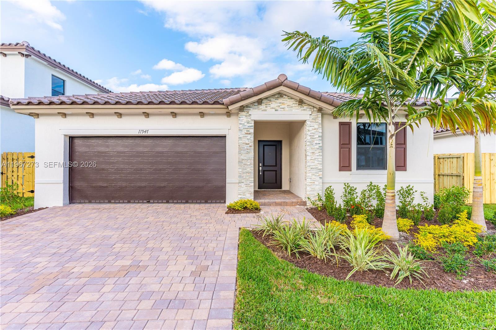 11947 Southwest 241 Terrace Homestead, FL 33032 - Photo 2 of 32 a front view of a house with garden