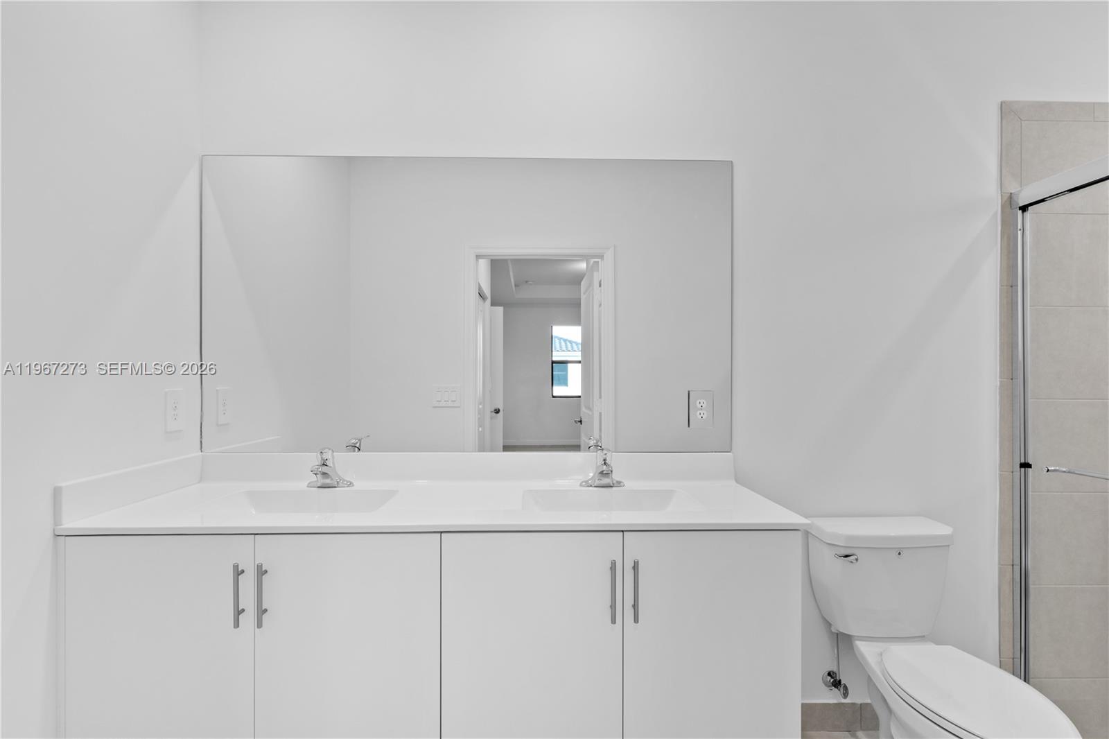 11947 Southwest 241 Terrace Homestead, FL 33032 - Photo 21 of 32 a bathroom with a sink and a toilet