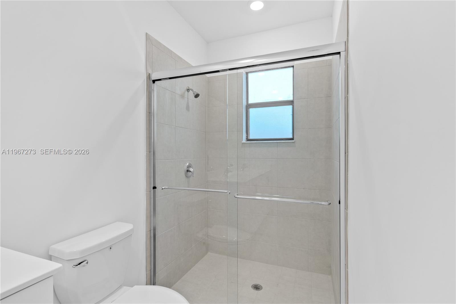 11947 Southwest 241 Terrace Homestead, FL 33032 - Photo 22 of 32 a bathroom with a shower and toilet