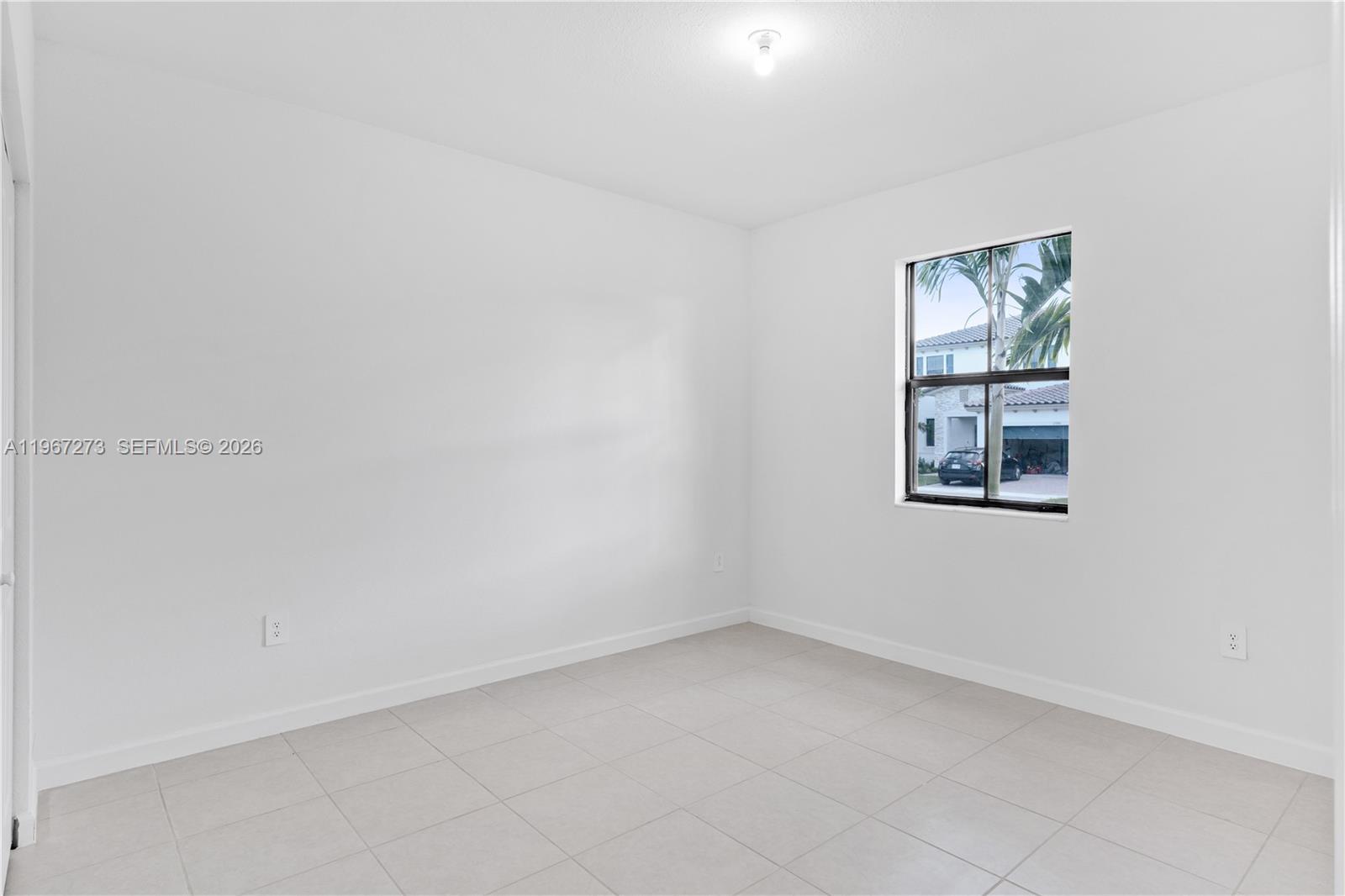 11947 Southwest 241 Terrace Homestead, FL 33032 - Photo 23 of 32 an empty room with windows