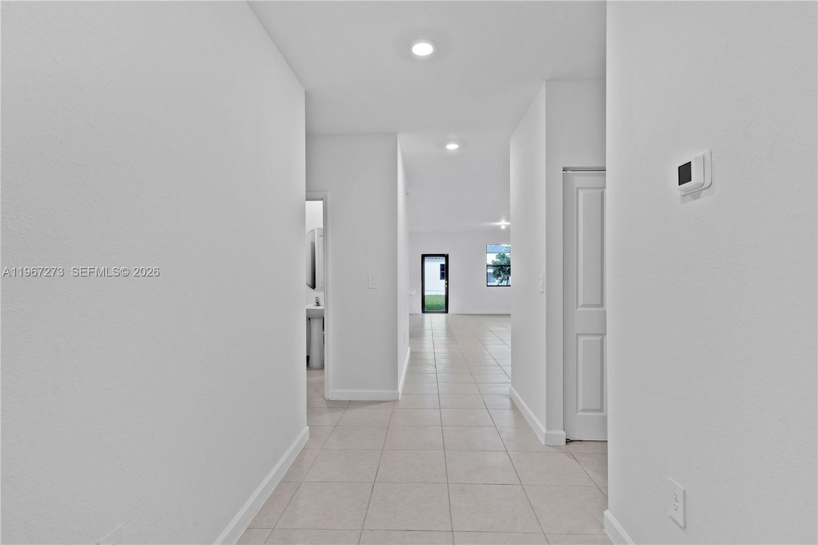 11947 Southwest 241 Terrace Homestead, FL 33032 - Photo 7 of 32 a view of a hallway with wooden shelves