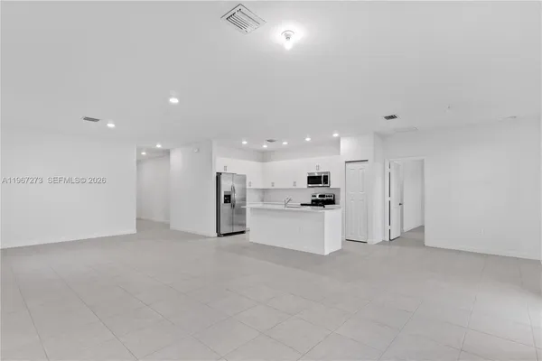 a view of a kitchen with refrigerator and microwave