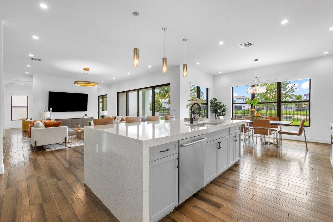 17128 Watersprite Lakes Road Boca Raton, FL 33496 - Photo 17 of 56 a large white kitchen with lots of counter space a sink and appliances
