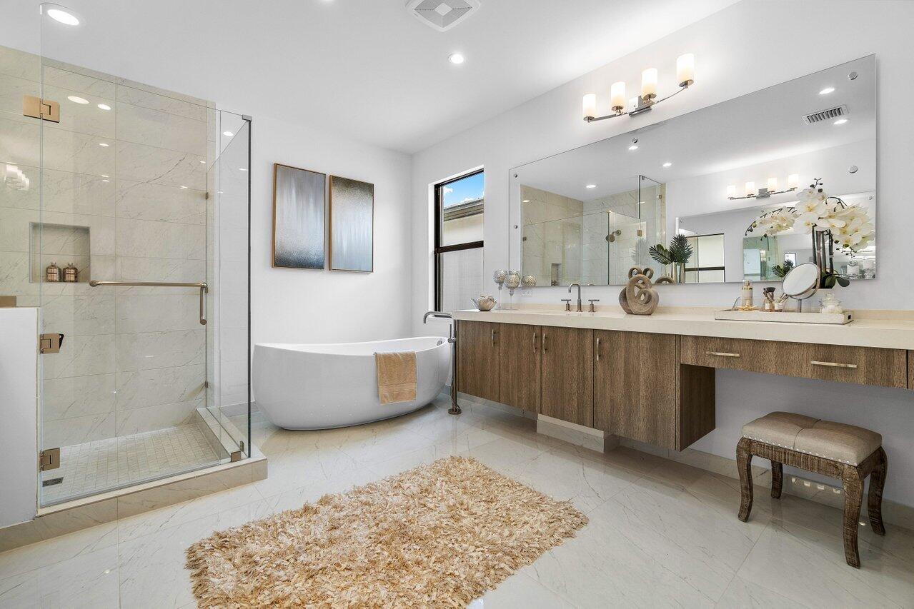 17128 Watersprite Lakes Road Boca Raton, FL 33496 - Photo 23 of 56 a bathroom with a tub a sink and a mirror