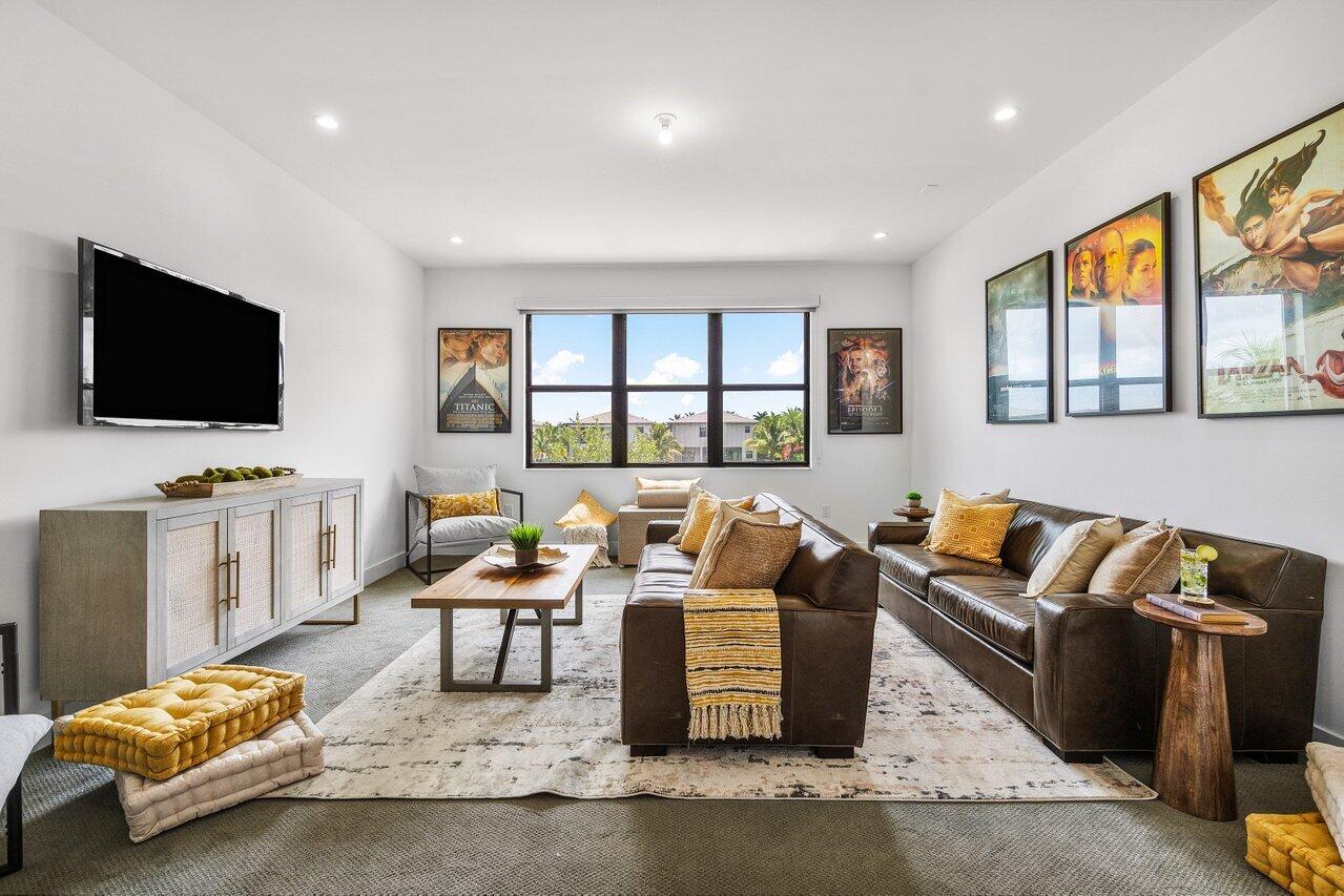 17128 Watersprite Lakes Road Boca Raton, FL 33496 - Photo 24 of 56 a living room with furniture and a flat screen tv