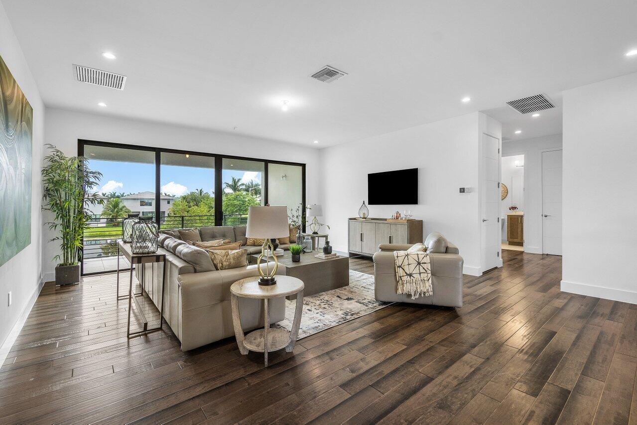 17128 Watersprite Lakes Road Boca Raton, FL 33496 - Photo 28 of 56 a living room with furniture flat screen tv and a large window