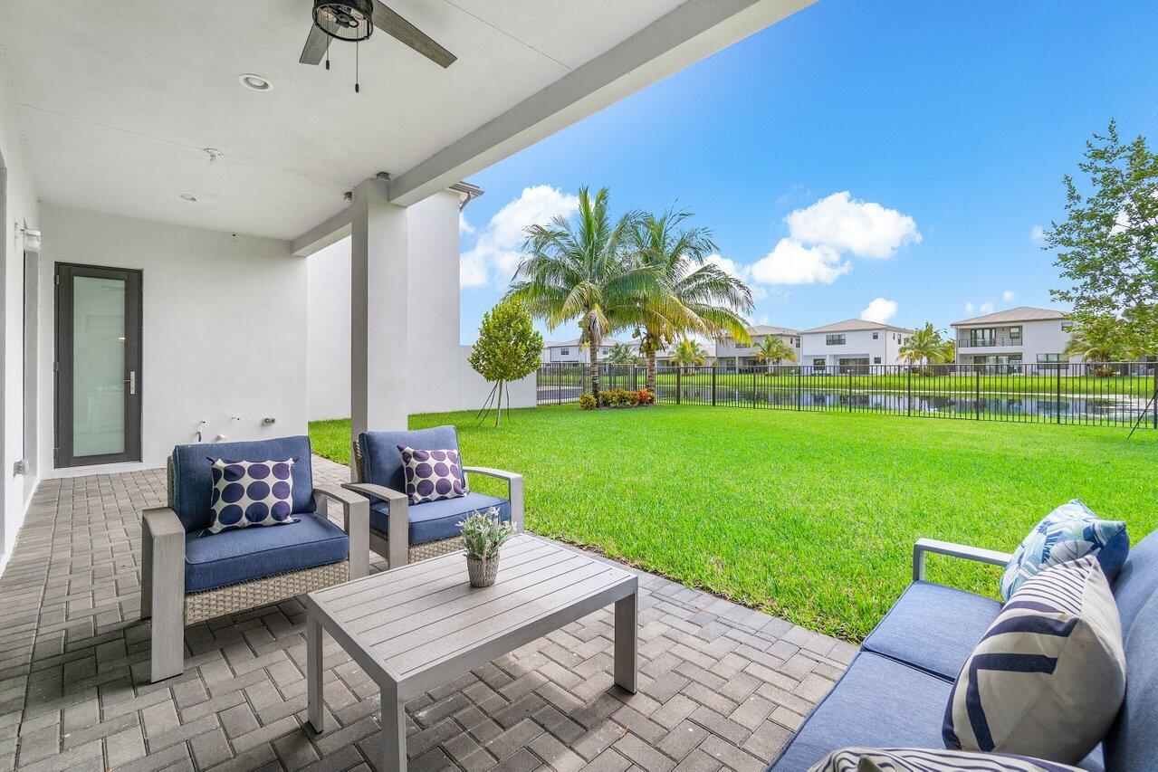 17128 Watersprite Lakes Road Boca Raton, FL 33496 - Photo 36 of 56 a outdoor living space with furniture and garden