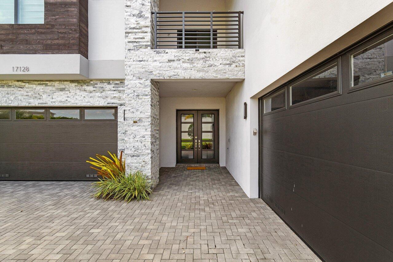 17128 Watersprite Lakes Road Boca Raton, FL 33496 - Photo 4 of 56 a front view of a house with garden