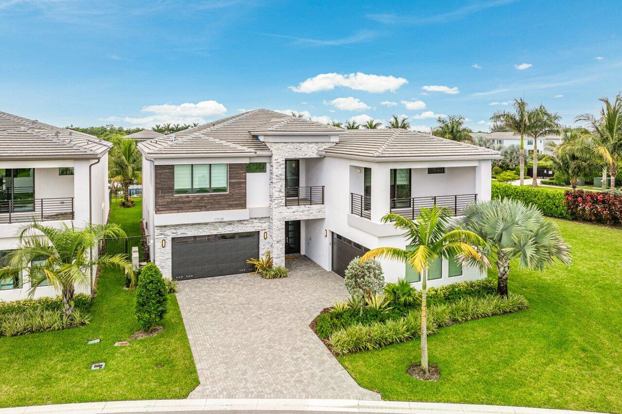 17128 Watersprite Lakes Road Boca Raton, FL 33496 - Photo 41 of 56 a view of house with a backyard porch and sitting area