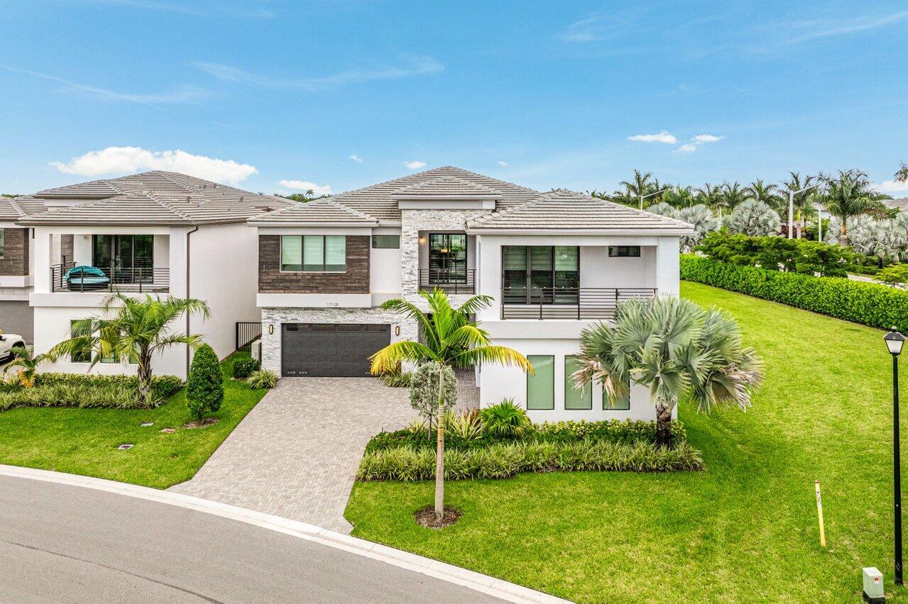 17128 Watersprite Lakes Road Boca Raton, FL 33496 - Photo 42 of 56 a front view of a house with a yard
