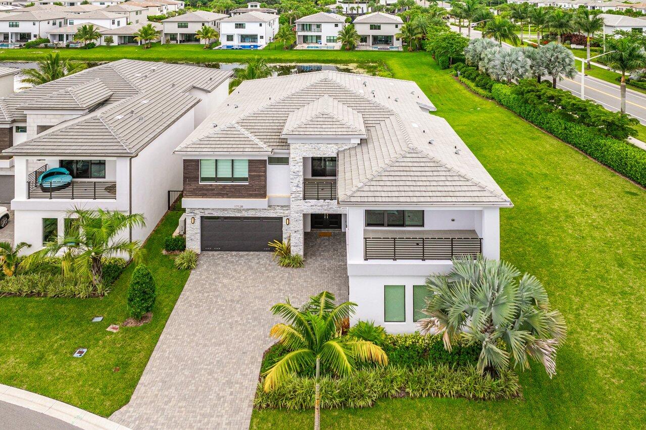 17128 Watersprite Lakes Road Boca Raton, FL 33496 - Photo 43 of 56 a aerial view of a house with a yard table and chairs