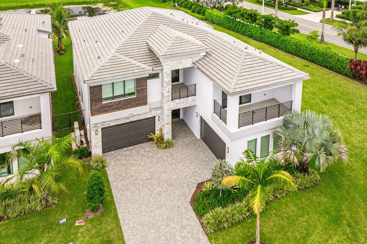 17128 Watersprite Lakes Road Boca Raton, FL 33496 - Photo 44 of 56 a front view of a house with garden