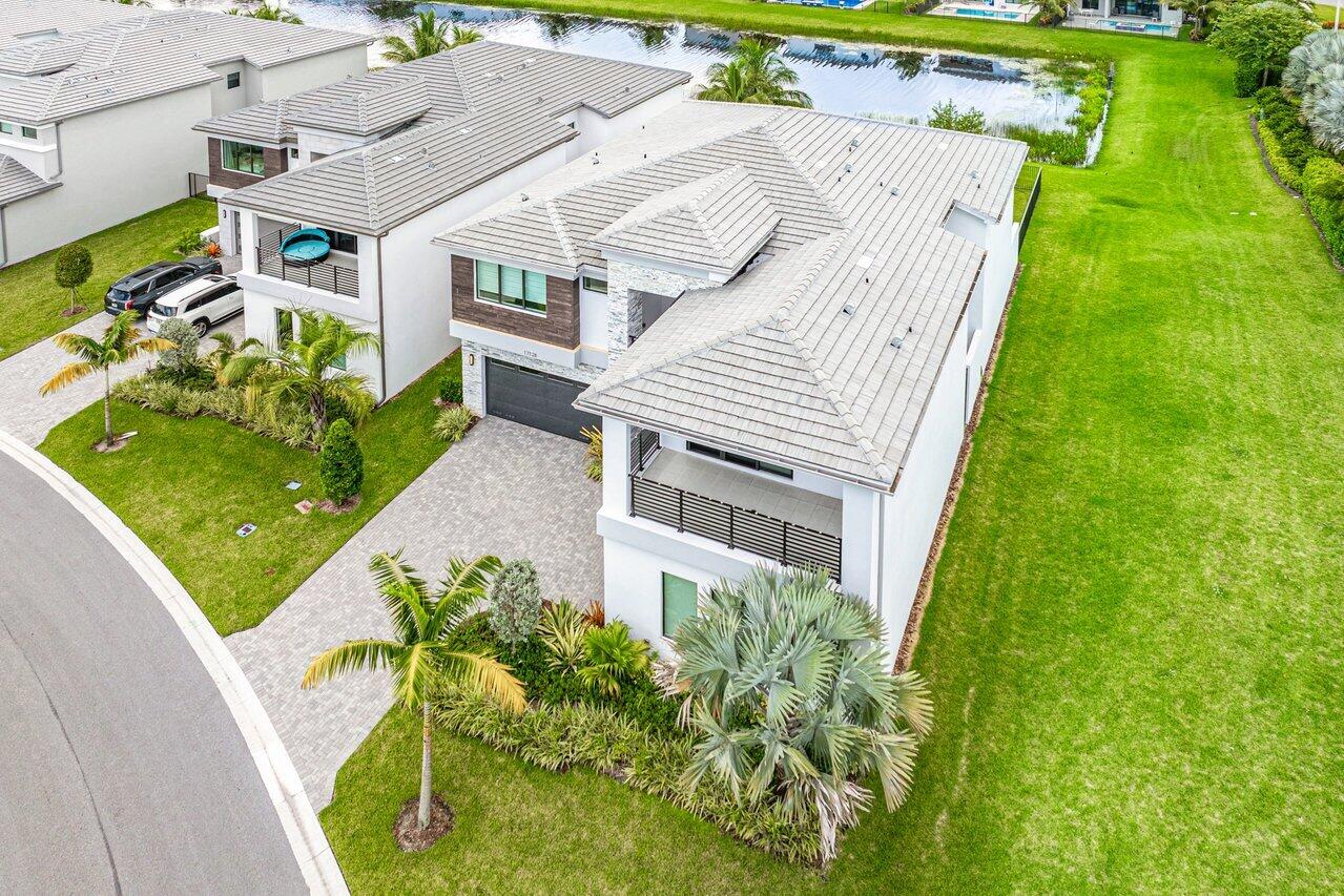 17128 Watersprite Lakes Road Boca Raton, FL 33496 - Photo 45 of 56 a aerial view of a house with a yard and potted plants
