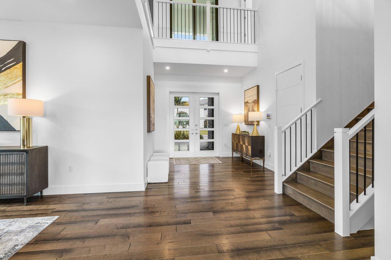 17128 Watersprite Lakes Road Boca Raton, FL 33496 - Photo 5 of 56 a view of an entryway with wooden floor and a livingroom