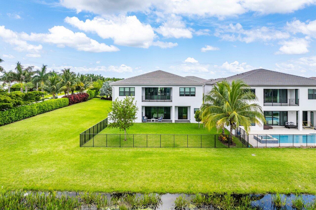 17128 Watersprite Lakes Road Boca Raton, FL 33496 - Photo 51 of 56 a front view of a house with a garden