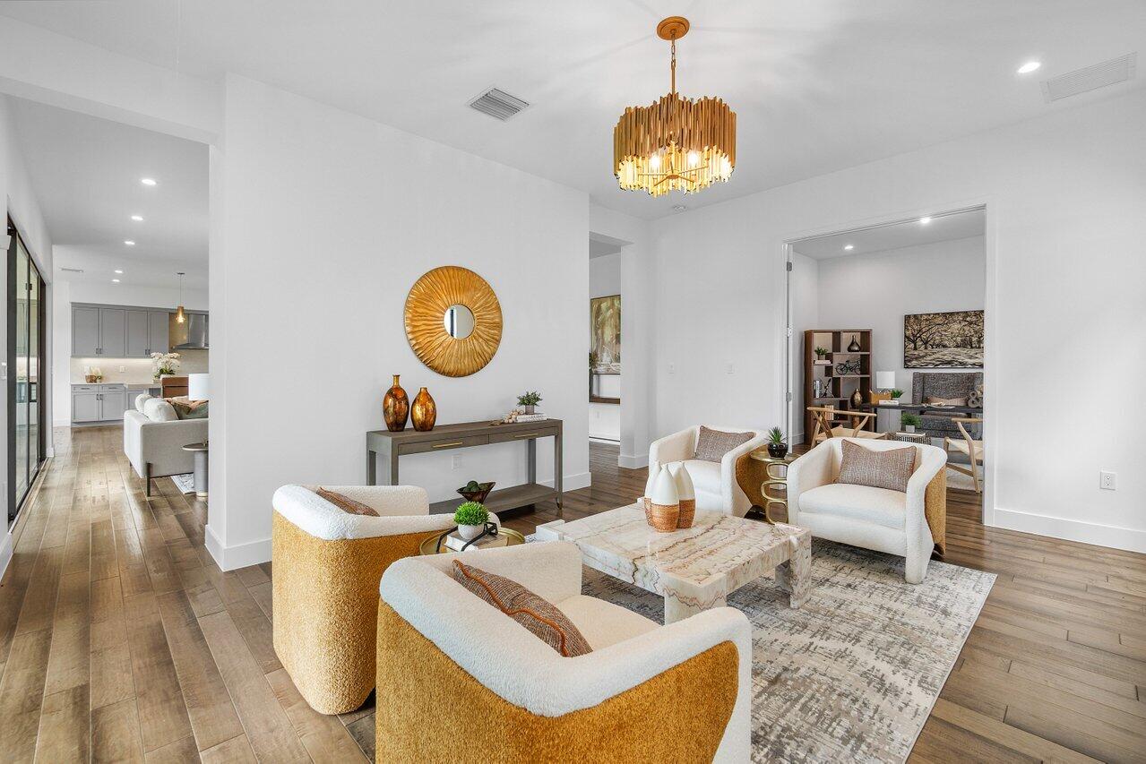 17128 Watersprite Lakes Road Boca Raton, FL 33496 - Photo 10 of 56 a living room with furniture a mirror and a clock