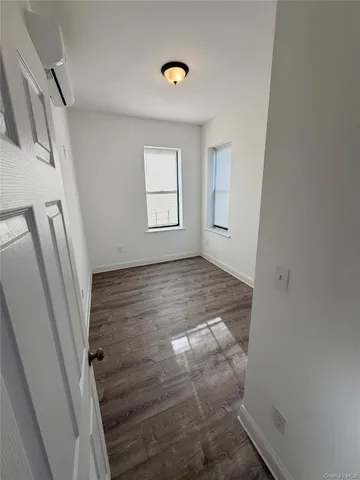 a view of room with window and hardwood floor