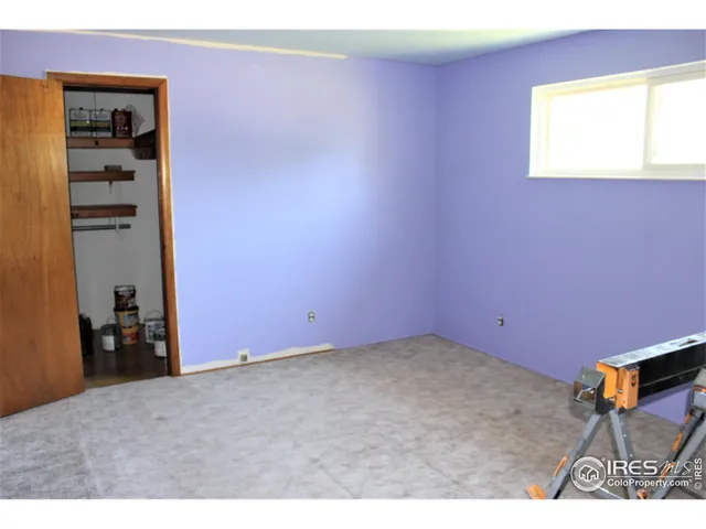 a view of an empty room and a window