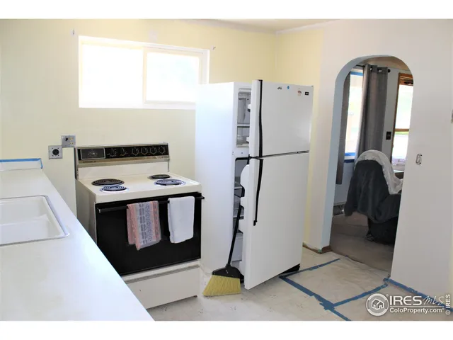 a kitchen with a refrigerator and a stove