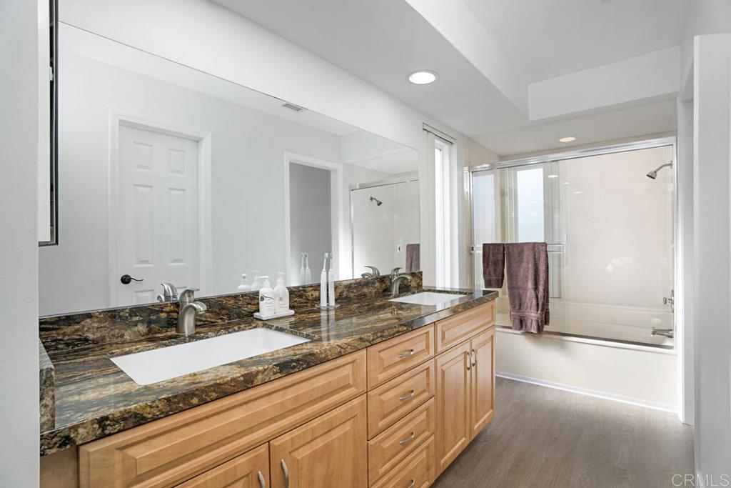 1237 Granada Way San Marcos, CA 92078 - Photo 23 of 27 a spacious bathroom with a granite countertop sink and a mirror
