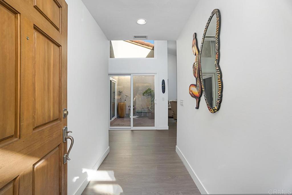 1237 Granada Way San Marcos, CA 92078 - Photo 4 of 27 a view of a hallway with wooden floor and entryway