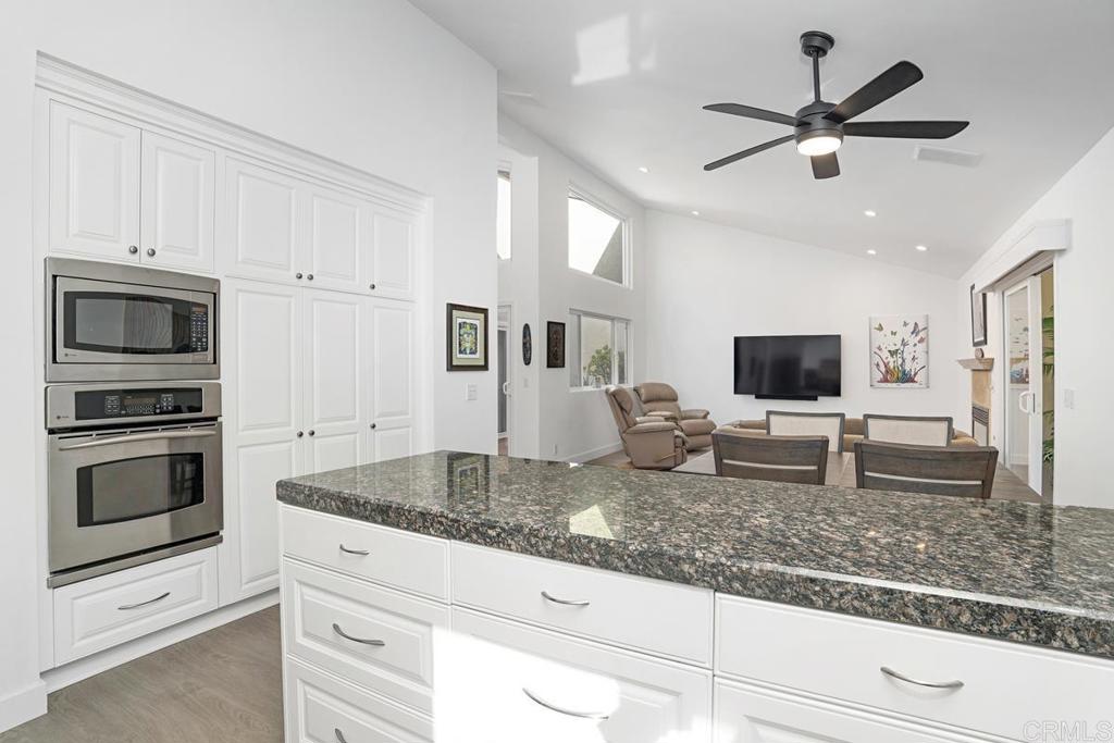 1237 Granada Way San Marcos, CA 92078 - Photo 10 of 27 a kitchen with granite countertop a stove and a microwave oven