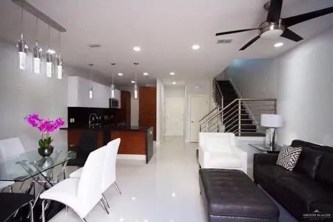 a living room with furniture and a chandelier
