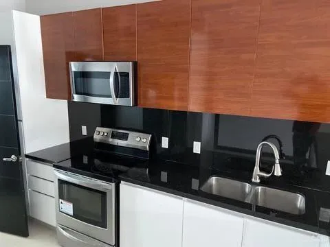 a kitchen with a sink and cabinets