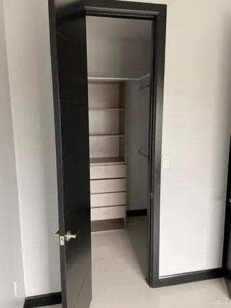 a view of walk in closet with empty racks