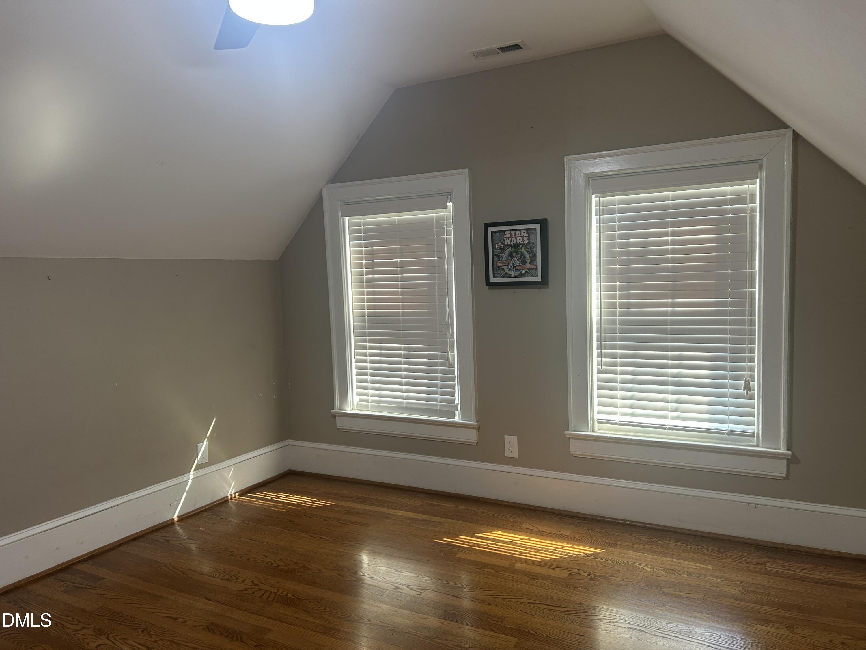 405 Sunset Avenue Clinton, NC 28328 - Photo 22 of 47 a view of an empty room with wooden floor and a window
