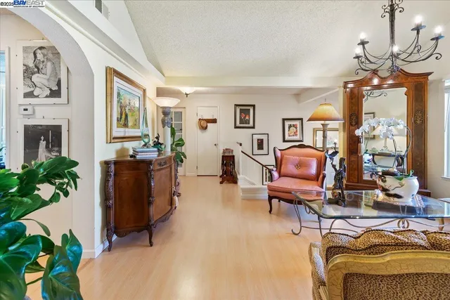 a living room with furniture and flowers