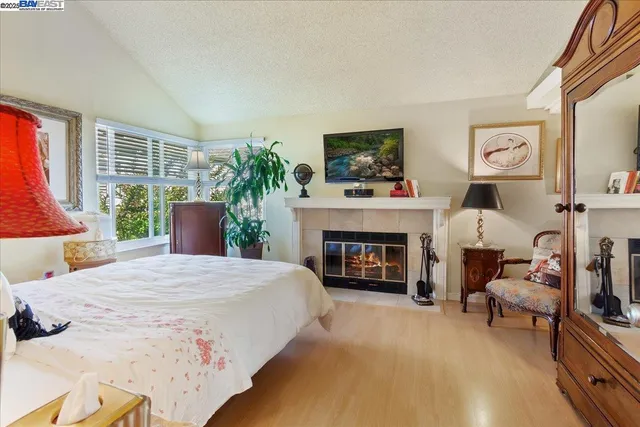 a bedroom with a bed and dresser with mirror