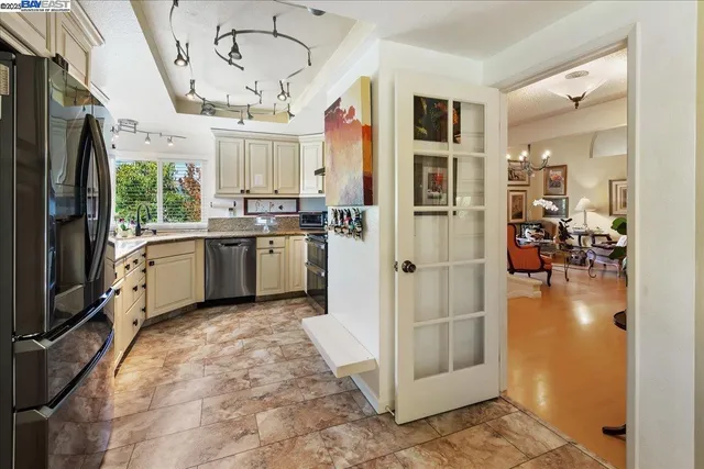 a kitchen with stainless steel appliances granite countertop a sink stove and cabinets