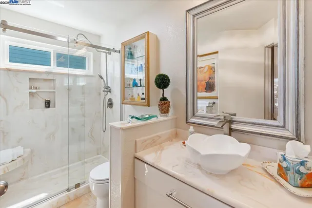 a view of staircase with railing and frames on wall