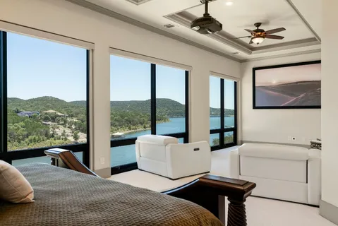 a living room with furniture and a floor to ceiling window