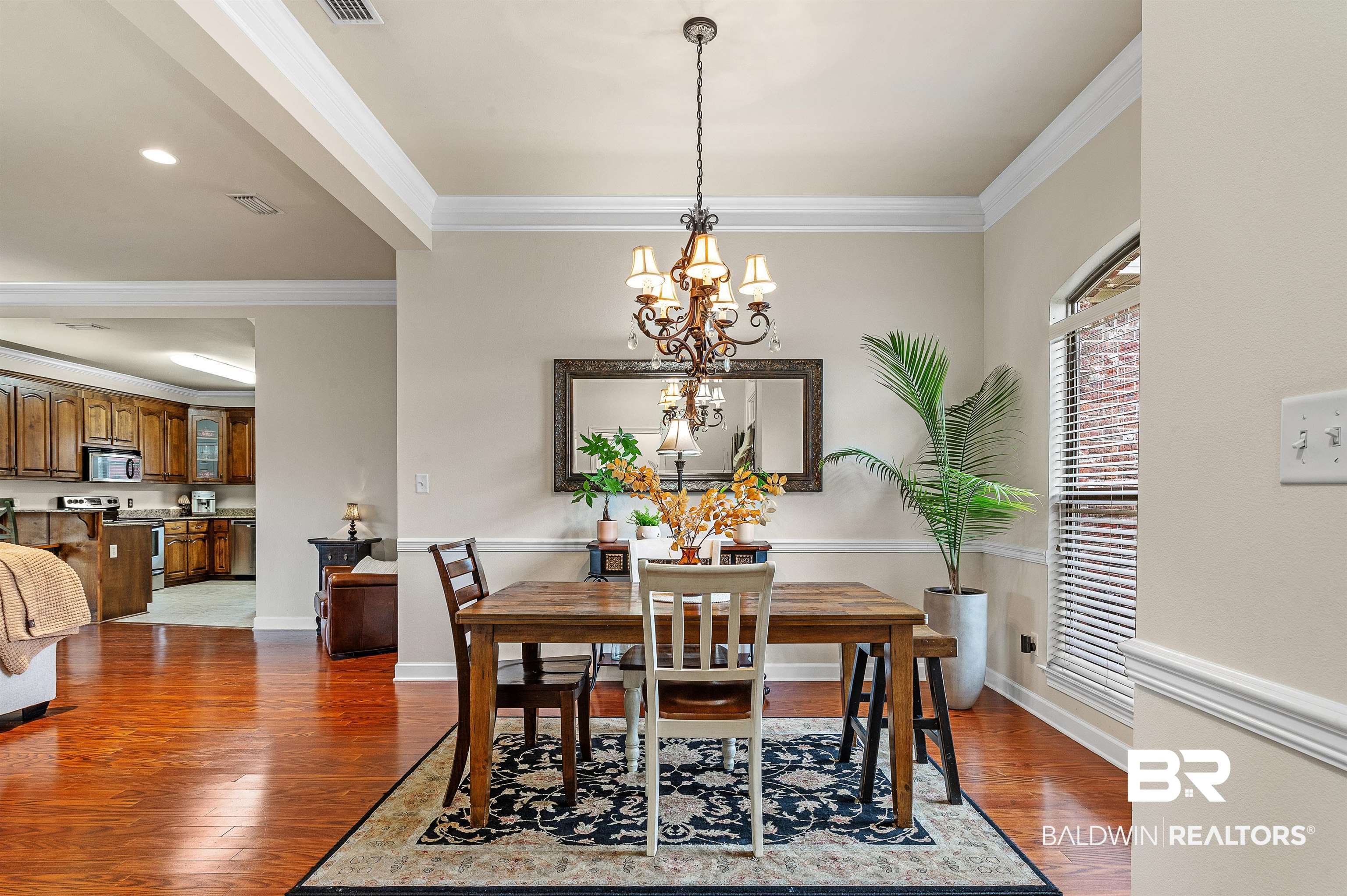 9376 Sable Court Daphne, AL 36526 - Photo 5 of 46 Dining room featuring ornamental molding, a chandelier, and dark hardwood / wood-style flooring