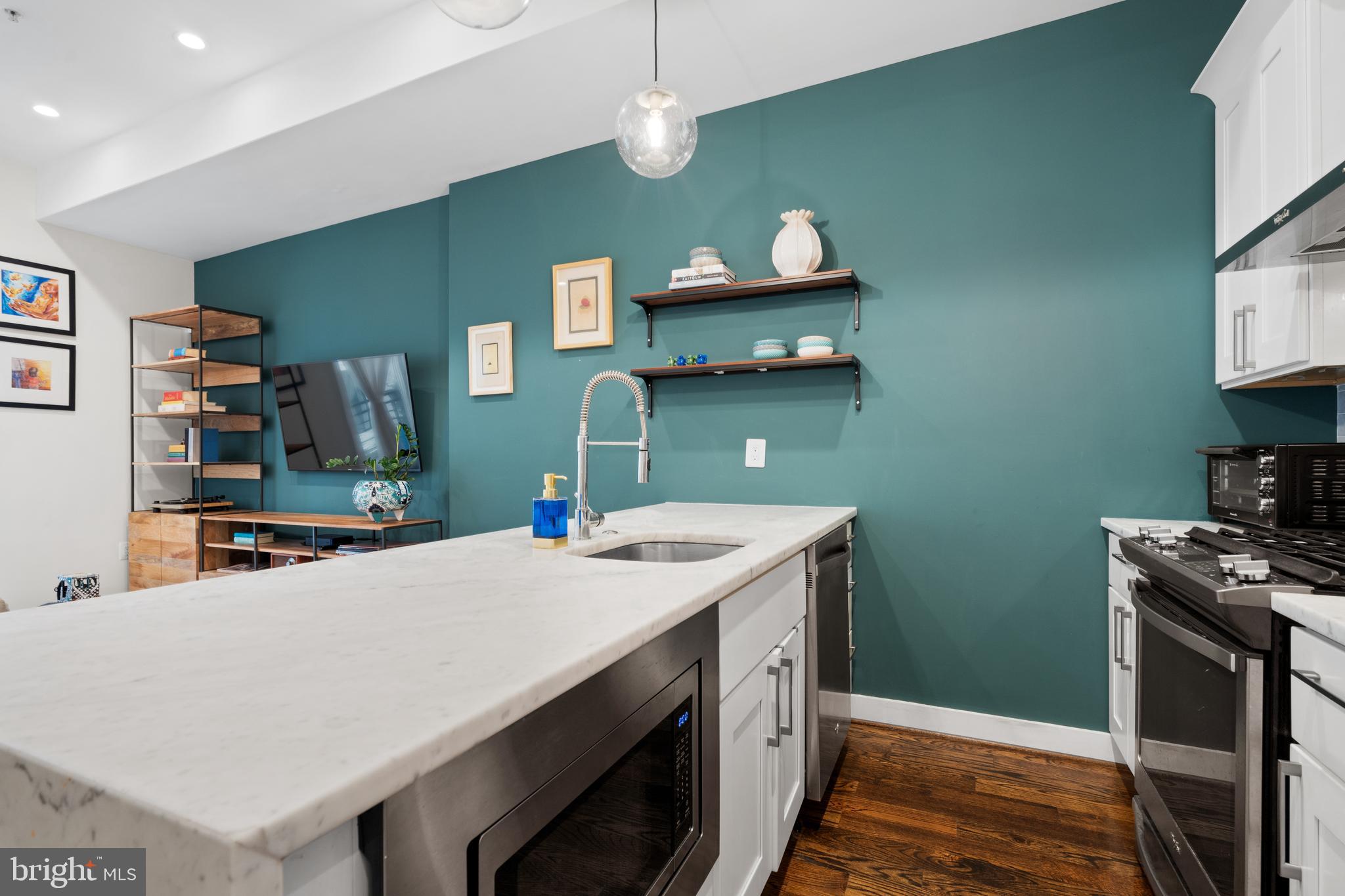 913 12th Street Northeast, Unit 4 Washington, DC 20002 - Photo 11 of 33 a kitchen with a sink a stove and a microwave