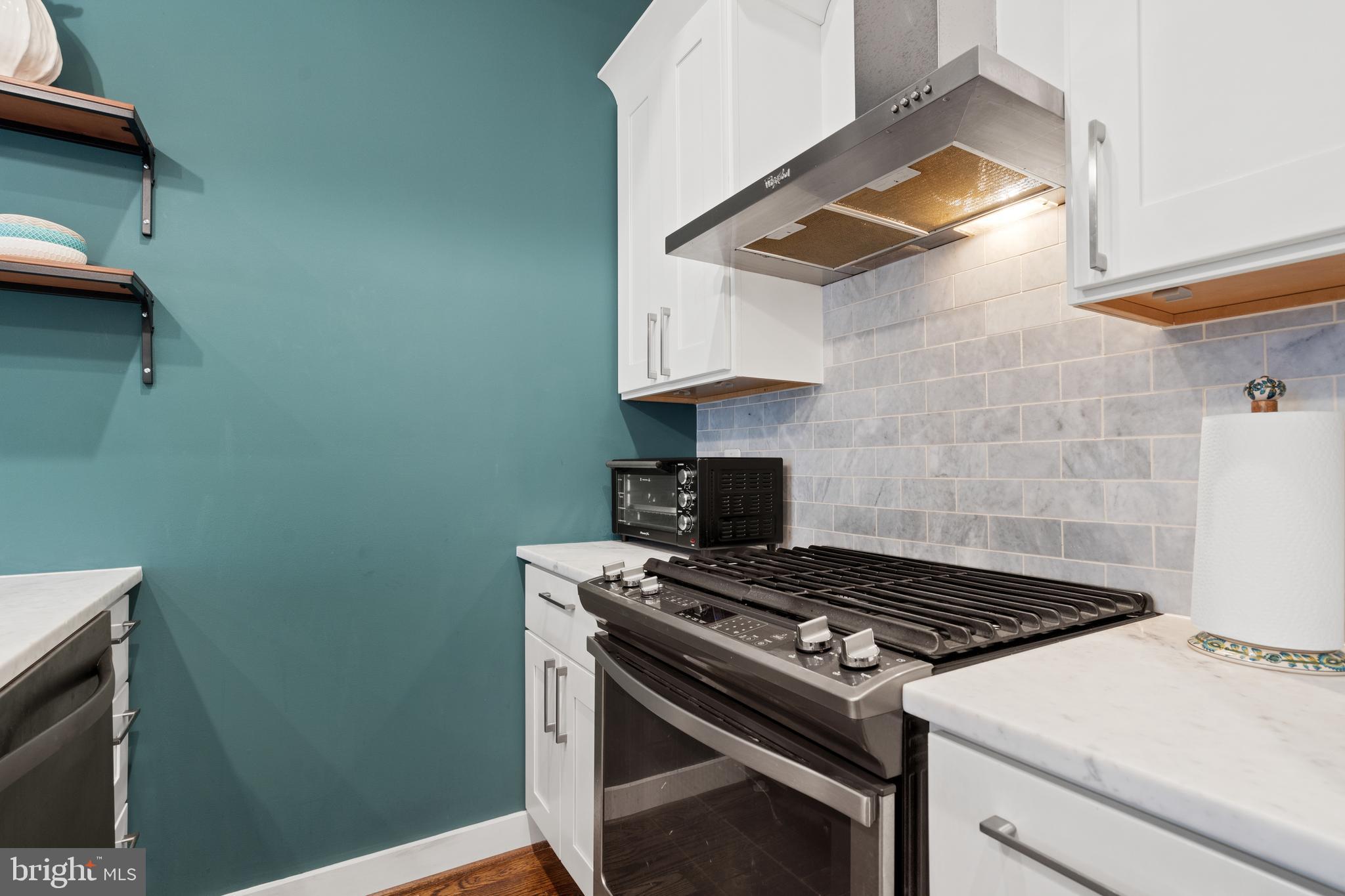 913 12th Street Northeast, Unit 4 Washington, DC 20002 - Photo 12 of 33 a stove top oven sitting inside of a kitchen