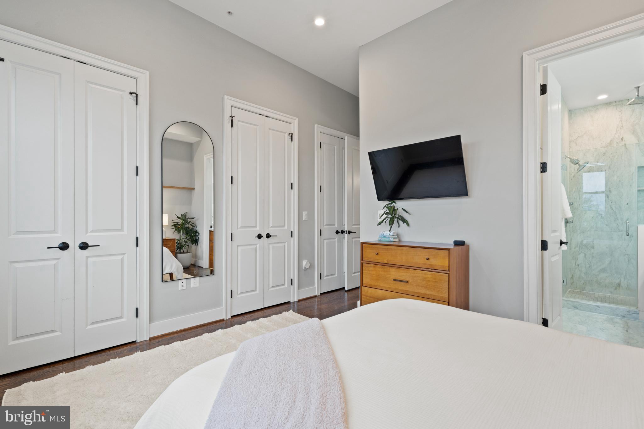 913 12th Street Northeast, Unit 4 Washington, DC 20002 - Photo 15 of 33 a bedroom with a bed and a flat tv screen in it