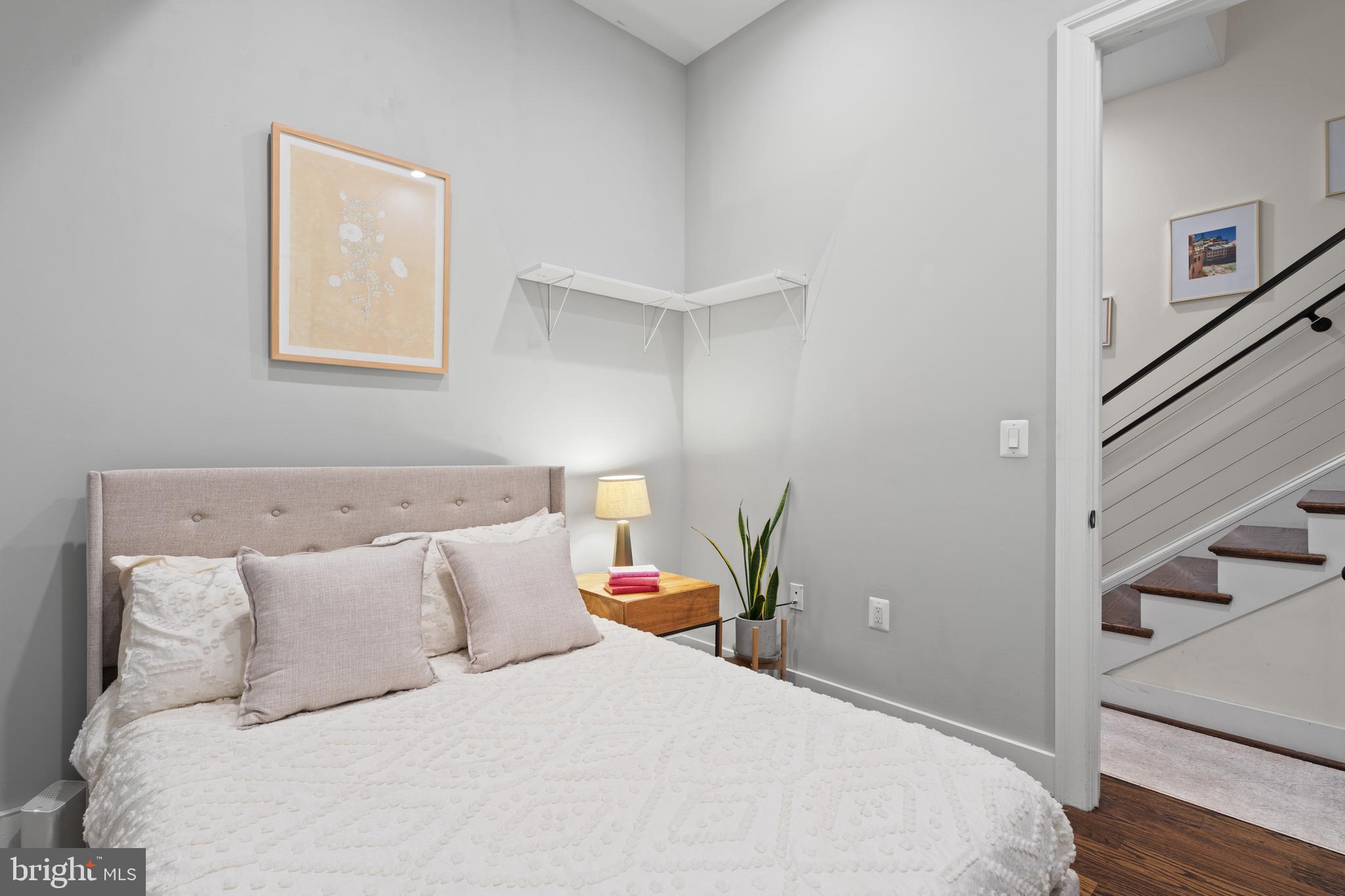 913 12th Street Northeast, Unit 4 Washington, DC 20002 - Photo 17 of 33 a bedroom with a bed and wooden floor
