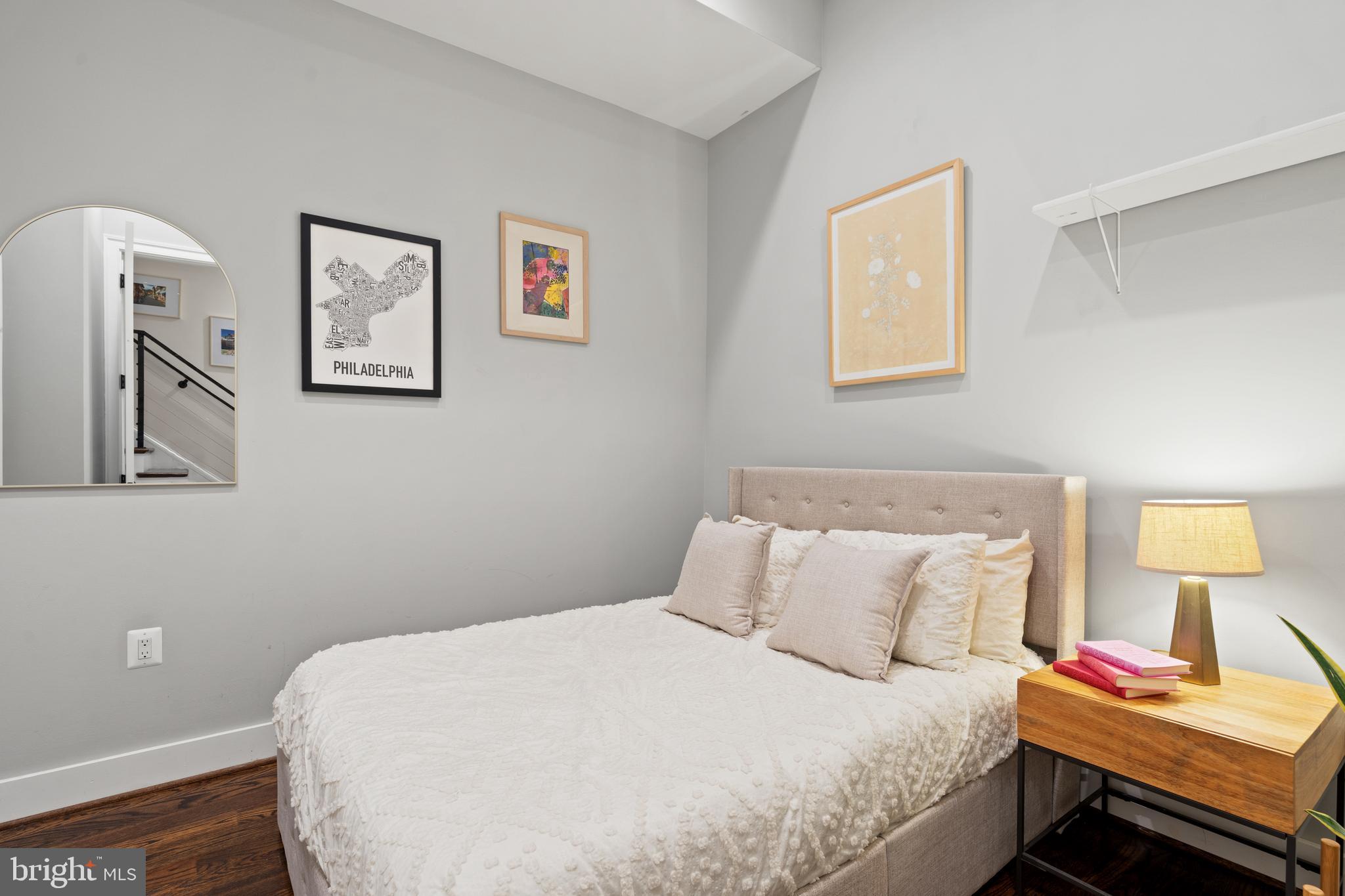 913 12th Street Northeast, Unit 4 Washington, DC 20002 - Photo 18 of 33 a bedroom with a bed and a lamp on dresser