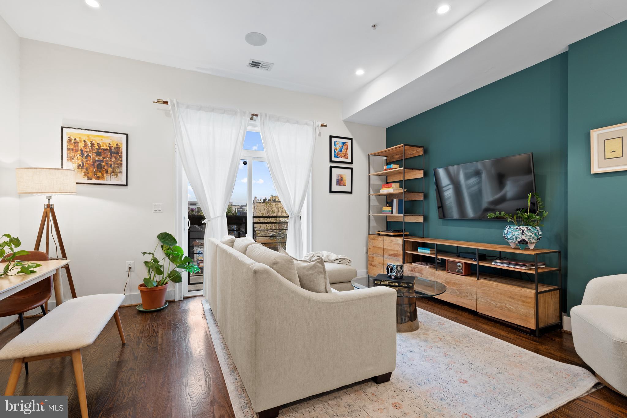 913 12th Street Northeast, Unit 4 Washington, DC 20002 - Photo 3 of 33 a living room with furniture and a flat screen tv
