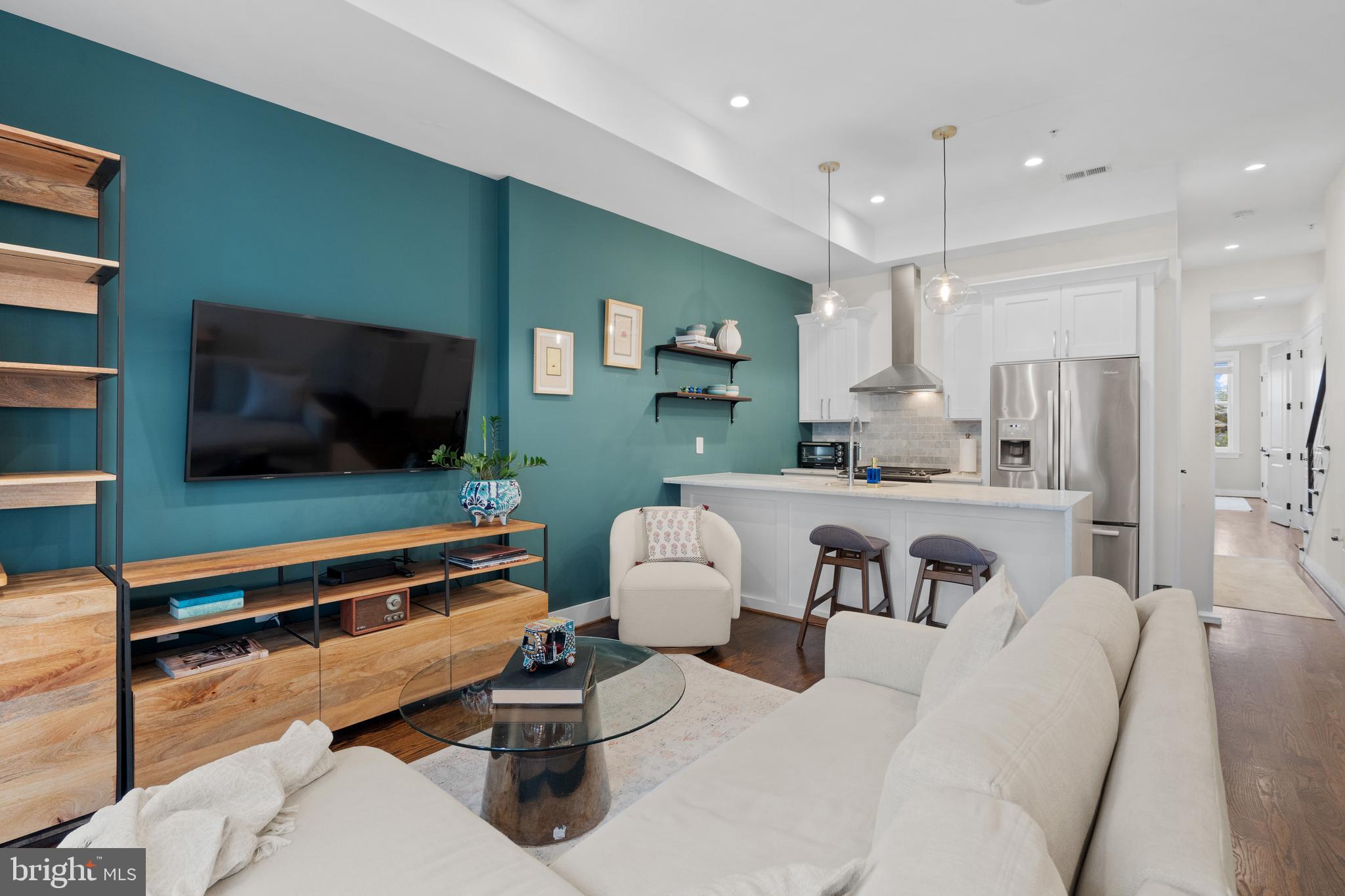 913 12th Street Northeast, Unit 4 Washington, DC 20002 - Photo 5 of 33 a living room with furniture and a flat screen tv