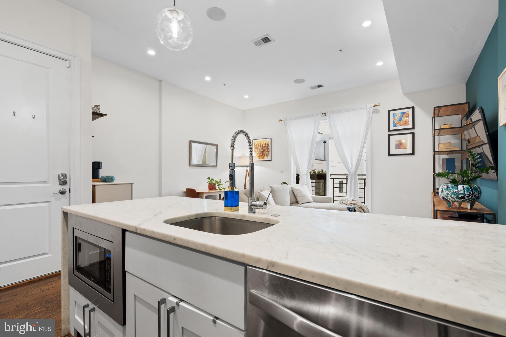 913 12th Street Northeast, Unit 4 Washington, DC 20002 - Photo 10 of 33 a kitchen with sink a oven and white cabinets