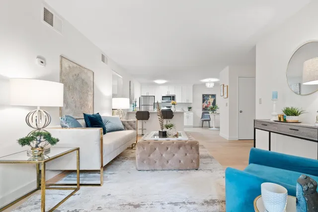 a living room with furniture and a lamp