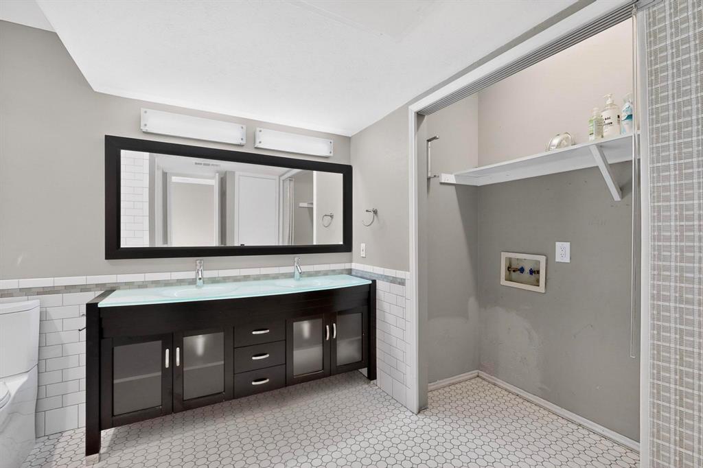 9222 Church Road, Unit 112 Dallas, TX 75231 - Photo 13 of 22 a bathroom with a sink a mirror and a vanity