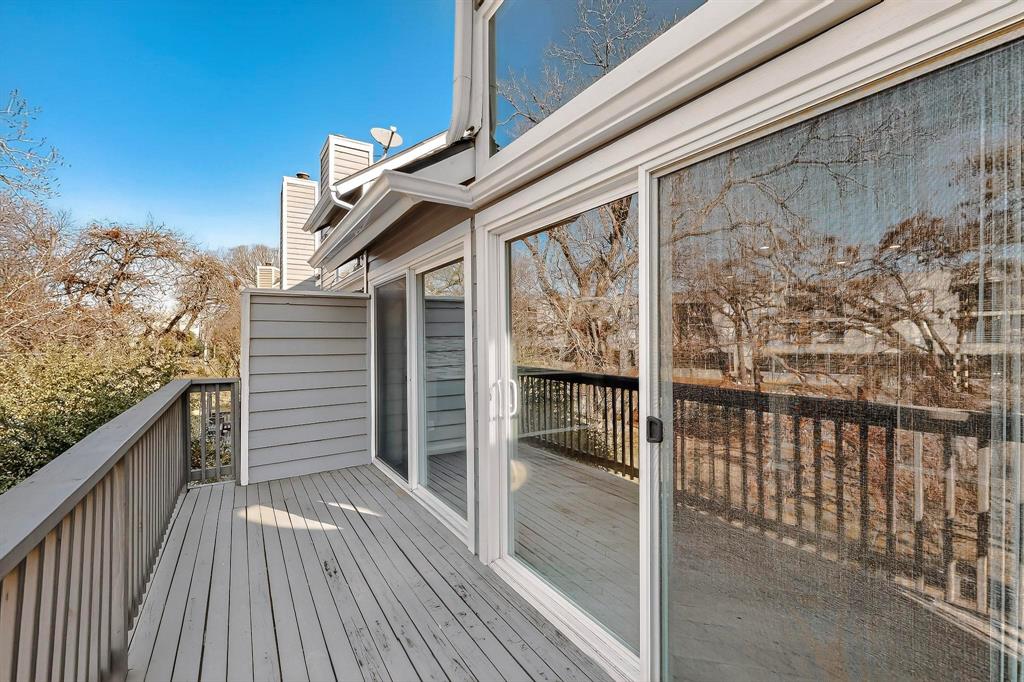 9222 Church Road, Unit 112 Dallas, TX 75231 - Photo 14 of 22 a view of a balcony with wooden floor and fence