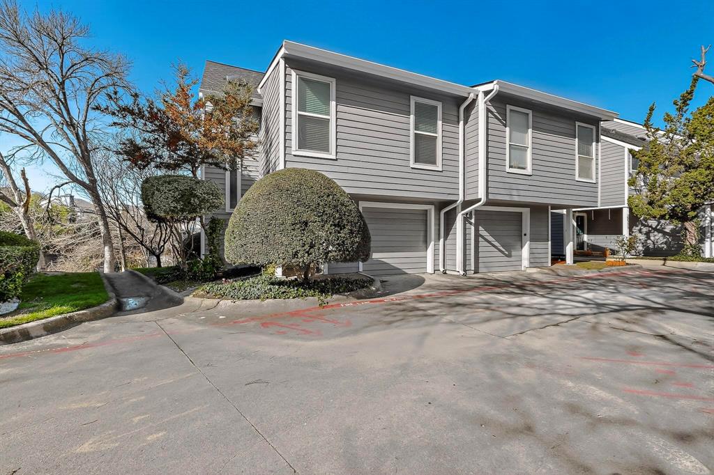9222 Church Road, Unit 112 Dallas, TX 75231 - Photo 22 of 22 a front view of a house with a yard and garage