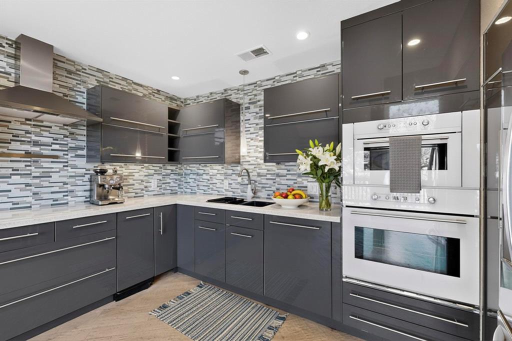 9222 Church Road, Unit 112 Dallas, TX 75231 - Photo 6 of 22 a kitchen with stainless steel appliances granite countertop a sink and cabinets