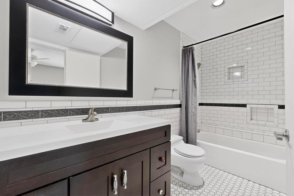 9222 Church Road, Unit 112 Dallas, TX 75231 - Photo 8 of 22 a bathroom with a sink a toilet and shower